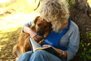 Woman reads book to dog